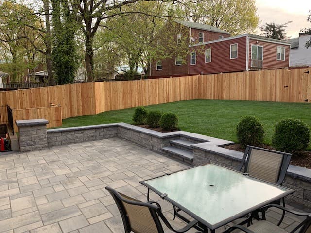Finished stone patio overlooking a newly installed lawn and plantings